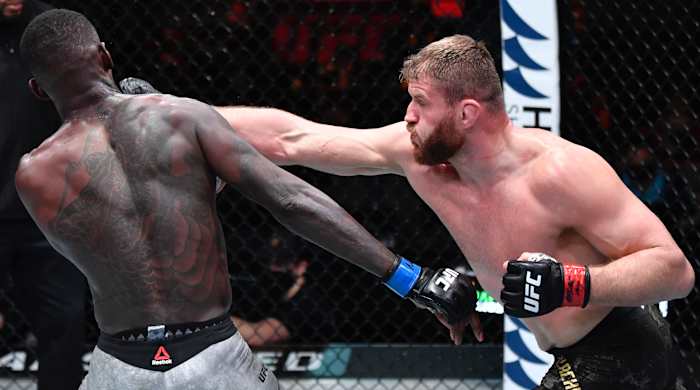 Jan Blachowicz of Poland punches Israel Adesanya of Nigeria in their UFC light heavyweight championship fight during the UFC 259 event at UFC APEX on March 06, 2021 in Las Vegas, Nevada.